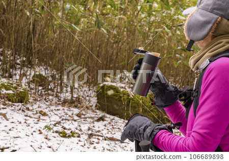 Enjoy winter mountain trekking with a hot drink Enjoy winter mountain trekking with a hot drink 106689898