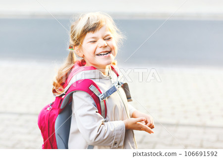 Cute little preschool girl going to playschool. Healthy toddler child walking to nursery school and kindergarten. Happy child with backpack on the city street, outdoors. Cute little preschool girl going to playschool. Healthy toddler child walking to nursery school and kindergarten. Happy child with backpack on the city street, outdoors. 106691592