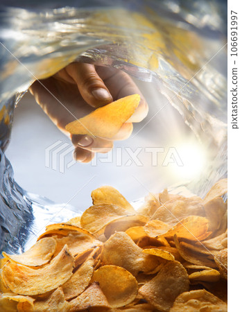 Potato chips. View from inside the package 106691997