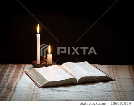 Still life from ancient book with candle 106691999