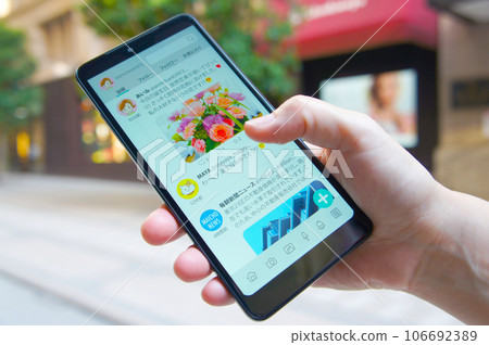 People using SNS at the shopping mall People using SNS at the shopping mall 106692389