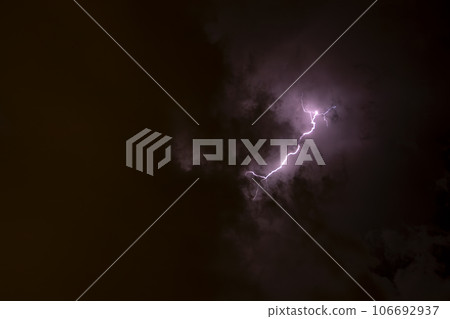 Ray. Storm. The sky is full of dark clouds in bad weather before a big storm rain. Light emission from the Edge of clouds. Zoom the surface of a Black haze at close range. 106692937