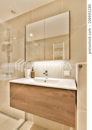 a bathroom with a sink, mirror and shower stall in the corner on the left is a white toilet next to the right is 106693280