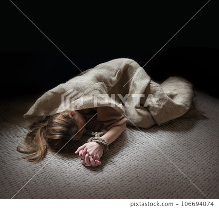The bound prisoner lies on the floor The bound prisoner lies on the floor 106694074