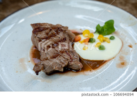 Medium rare meat served on plate on the table 106694894
