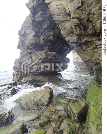 rock with a big hole 106694975