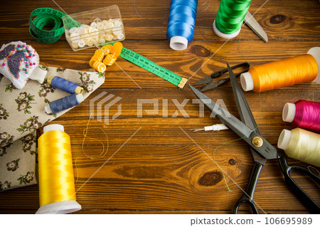 a set of tools and threads for sewing clothes 106695989