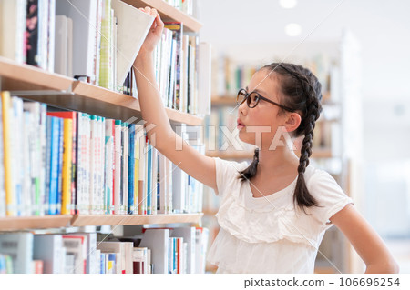 A girl choosing a book A girl choosing a book 106696254