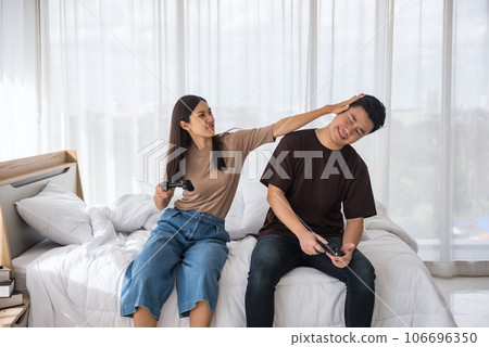 Mad Asian girlfriend push boyfriend's head she losing game 106696350