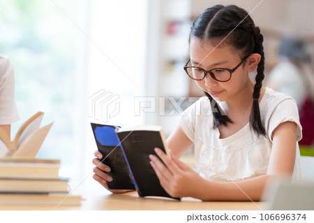 A girl choosing a book 106696374