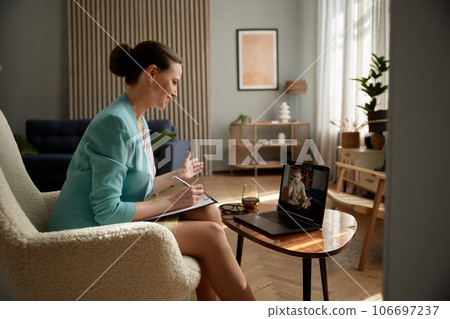 Woman psychologist consulting soldier online holding virtual therapy on laptop Woman psychologist consulting soldier online holding virtual therapy on laptop 106697237