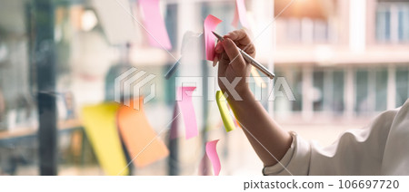 Cropped image of businesswoman writing information on paper, planning goals, manage corporate work tasks 106697720