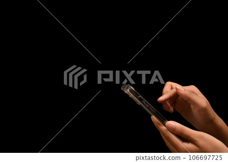 Woman hand holding smartphone isolated on black background with copy space for advertise text 106697725