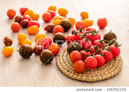 Small red cherry tomatoes on rustic background 106701230