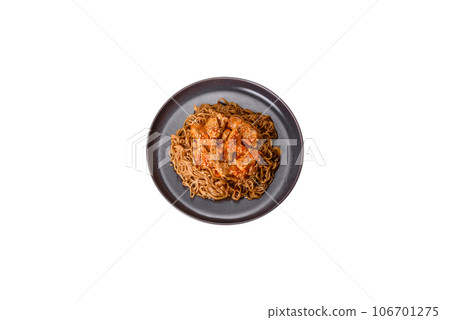Thai noodle and chicken plate on a black concrete background with Chinese chopsticks and copy space Thai noodle and chicken plate on a black concrete background with Chinese chopsticks and copy space 106701275