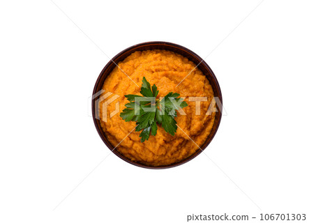 Squash caviar with garlic and tomatoes in a rustic bowl on a dark background Squash caviar with garlic and tomatoes in a rustic bowl on a dark background 106701303