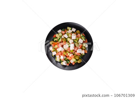 Greek salad with juicy tomatoes, feta cheese, lettuce, green olives, cucumber, red onion and fresh parsley 106701309