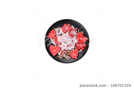 Gingerbread, Christmas tree decorations, dried citrus fruits on a gray concrete background 106701329