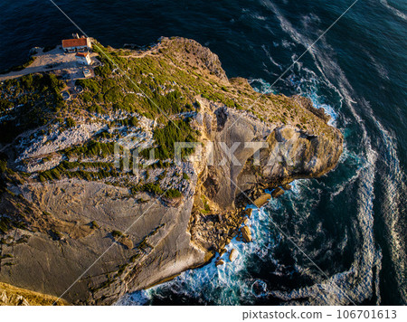Aerial drone view of Cabo Espichel cape Espichel on Atlantic ocean at sunset with ruins Aerial drone view of Cabo Espichel cape Espichel on Atlantic ocean at sunset with ruins 106701613