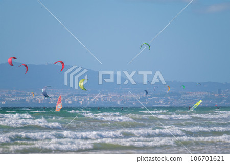 Kiteboarding kitesurfing kiteboarder kitesurfer kites on the Atlantic ocean beach at Fonte da Telha beach, Costa da Caparica, Portugal Kiteboarding kitesurfing kiteboarder kitesurfer kites on the Atlantic ocean beach at Fonte da Telha beach, Costa da Caparica, Portugal 106701621