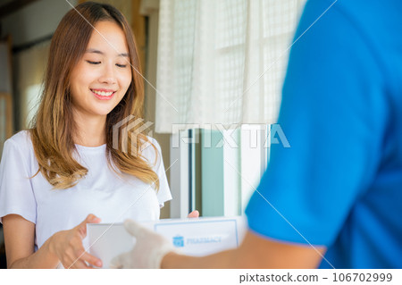 Delivery man give medicine drug store to patient female at front home, healthcare medicine online business, Asian woman sick she receive medication first aid pharmacy box hospital delivery service 106702999