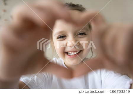 Positive sweet little preschool girl looking at camera Positive sweet little preschool girl looking at camera 106703249