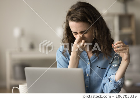 Unhappy exhausted freelance business professional girl tired of glasses 106703339