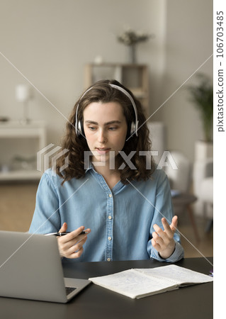 Focused pretty conference speaker girl giving webinar, speaking at laptop Focused pretty conference speaker girl giving webinar, speaking at laptop 106703485