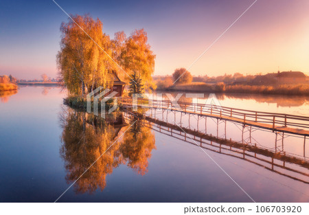 Old fisherman house and wooden pier at sunrise in autumn 106703920
