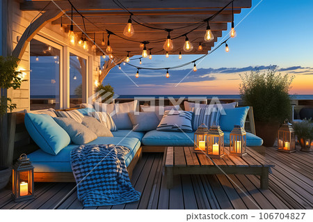 Nice cozy terrace with evening lanterns and soft sofas. 106704827