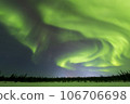 A curtain of aurora borealis hangs over the night sky in Yellowknife 106706698