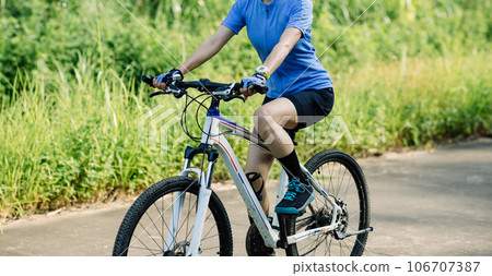 Riding bike in summer forest Riding bike in summer forest 106707387