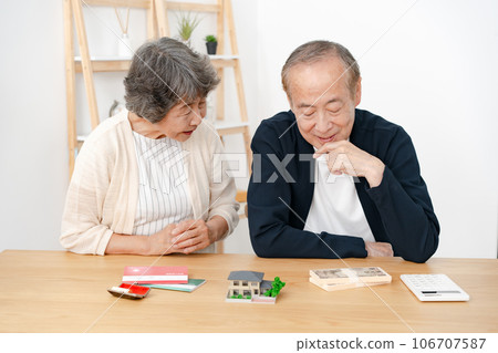 Senior couple real estate house model money Senior couple real estate house model money 106707587