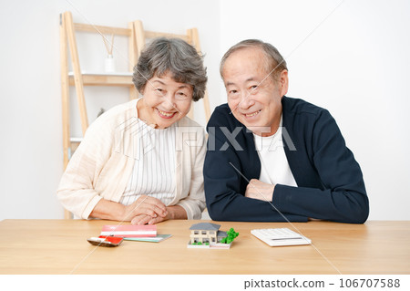 Senior couple real estate house model smile Senior couple real estate house model smile 106707588
