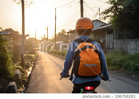 a person on a bike riding down the street with a backpack strapped to it's back and wearing an orange helmet a person on a bike riding down the street with a backpack strapped to it's back and wearing an orange helmet 106708261