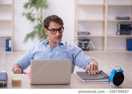 Young male employee working in the office Young male employee working in the office 106709697