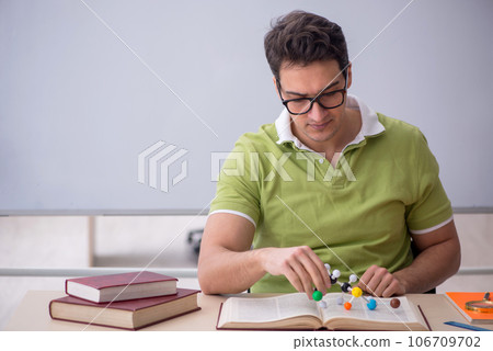 Young male student physicist sitting in the classroom Young male student physicist sitting in the classroom 106709702