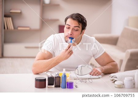 Young man shaving face at home Young man shaving face at home 106709755