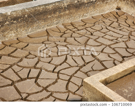 Dry and cracked soil or sediment of the treatment pond Dry and cracked soil or sediment of the treatment pond 106710069