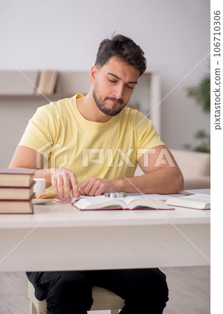Young male student studying at home 106710306