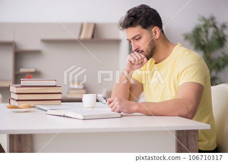 Young male student studying at home 106710317