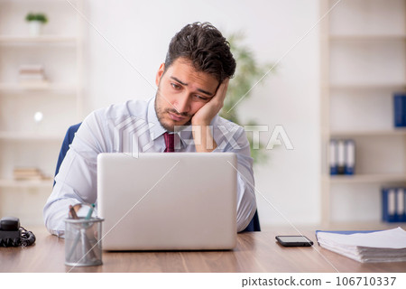 Young male employee working in the office 106710337