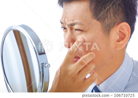 A man in his 40s who is concerned about his skin condition A man in his 40s who is concerned about his skin condition 106710725