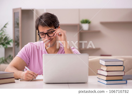 Young male student preparing for exams at home 106710782