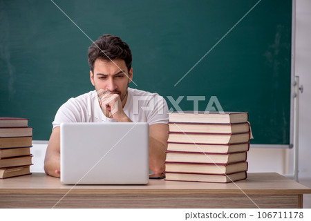 Young male student sitting in the classroom 106711178