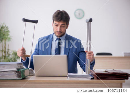 Young male employee after car accident working in the office Young male employee after car accident working in the office 106711184
