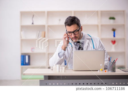 Young male doctor in telemedicine concept 106711186