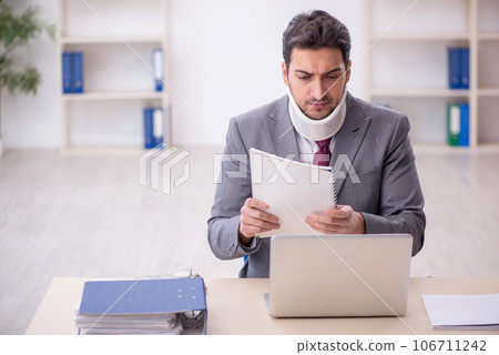 Young male employee after car accident sitting in the office Young male employee after car accident sitting in the office 106711242