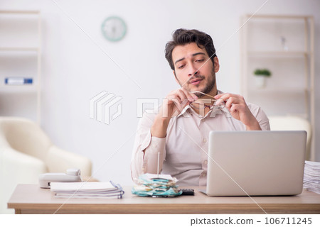 Young male accountant working in the office 106711245
