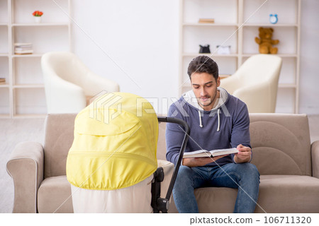 Young man looking after newborn at home Young man looking after newborn at home 106711320